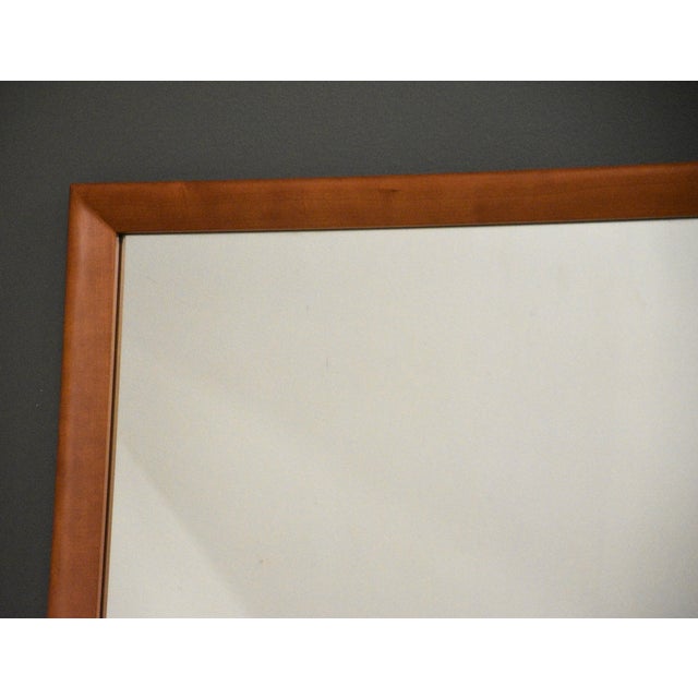 A solid cherry wall hanging mirror