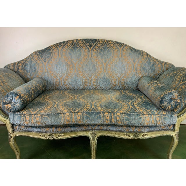 This Early Nineteenth Century Settee is a show stopper! The sensual lines of the carved frame is painted in a subtle...