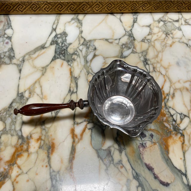 A lovely silver plated sauce pot / gravy bowl with a wooden handle. Handle has some wear and tear - needs to be...