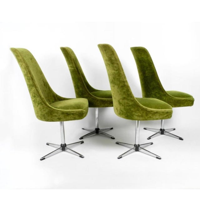A striking set of four mid-century Space Age swivel dining chairs designed by Interlübke, Germany, circa 1968....