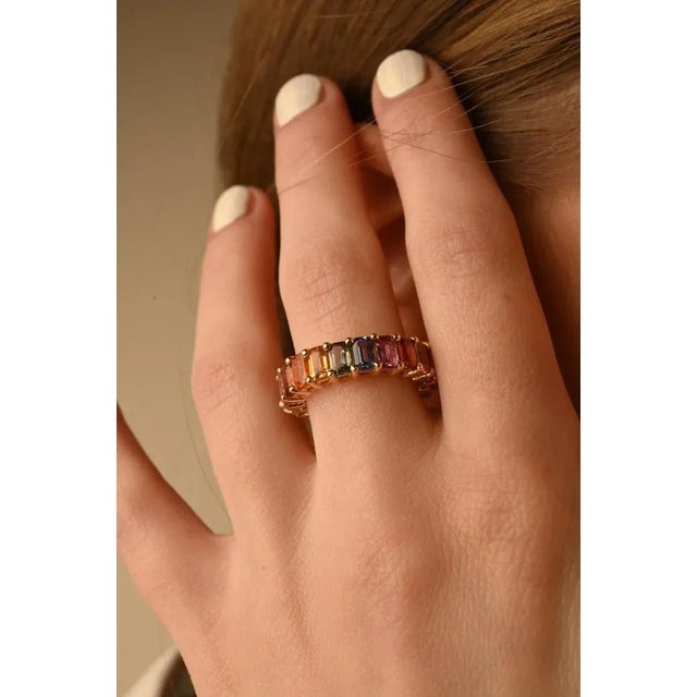This is part of Chairish’s Fine Jewelry assortment. Multi sapphire eternity band ring in 18K gold symbolises the...