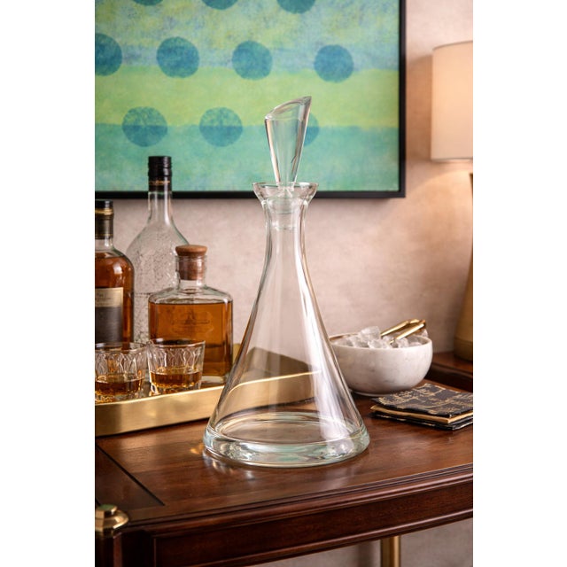 A striking modernist crystal decanter defined by its clean geometry and sculptural silhouette, this elegant piece embodies...