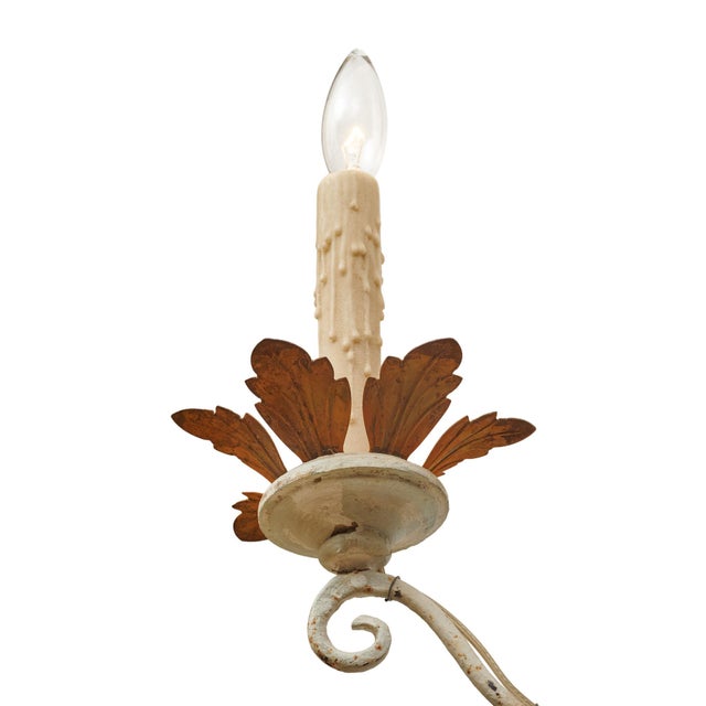 Pair of sconces from Italy in the “Arte Povera” style, made of painted and patinated wood. The pair has a lovely Trianon...