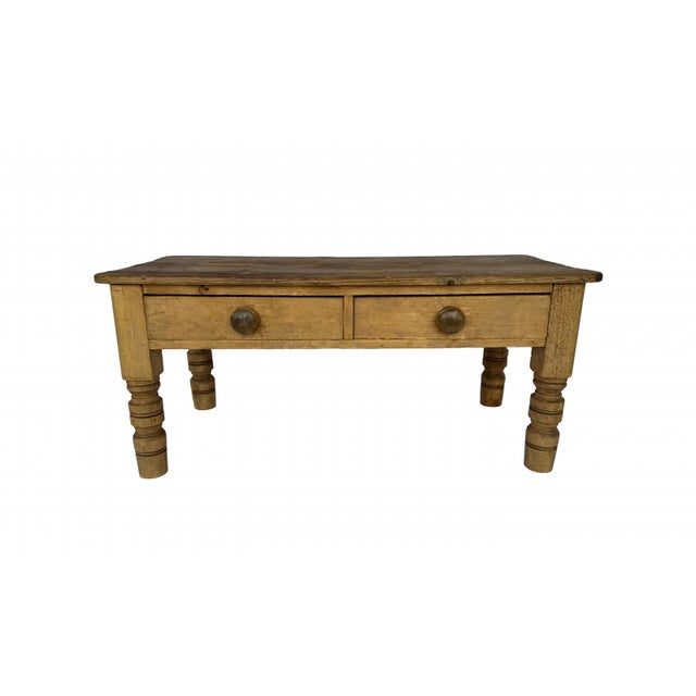 A charming late 19th-century Country English pine low table, showcasing the warmth and character of naturally aged timber....