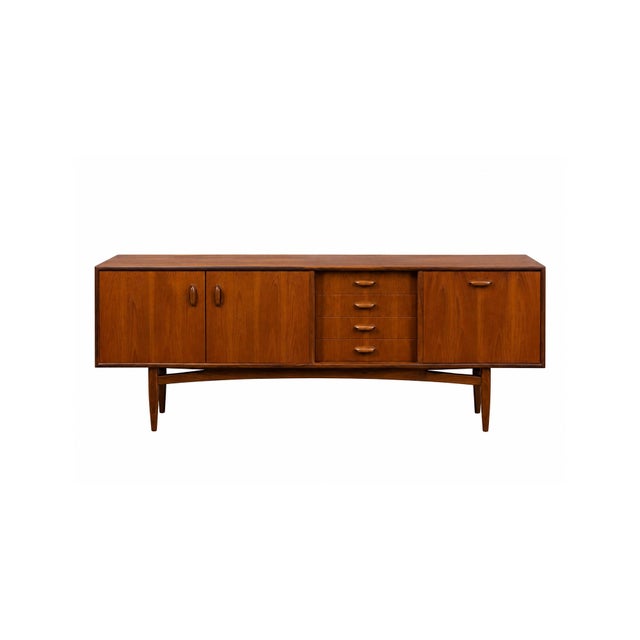 This mid-century Danish modern teak sideboard, designed by H.P. Hansen, is a stunning example of Scandinavian...