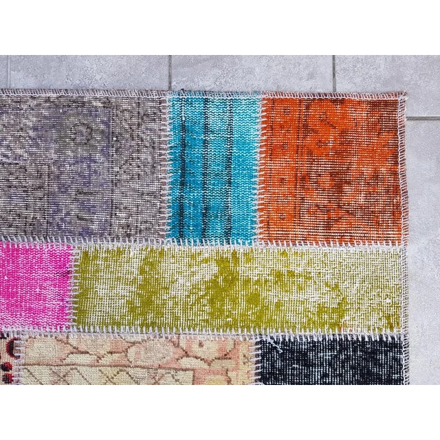 This is a vintage Turkish Oushak rug from the Mid 20th Century. The piece was hand-knotted.