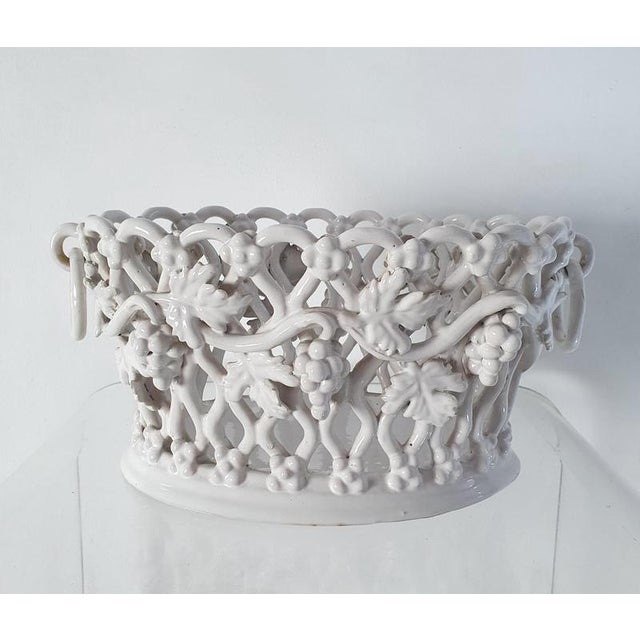 A medium sized handmade ceramic bowl with a basked design decorated with vine leaves and grapes. Is perfect to use for...