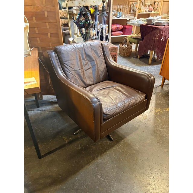 Beautiful lines and great wear on the dark brown leather. Super comfortable chair!