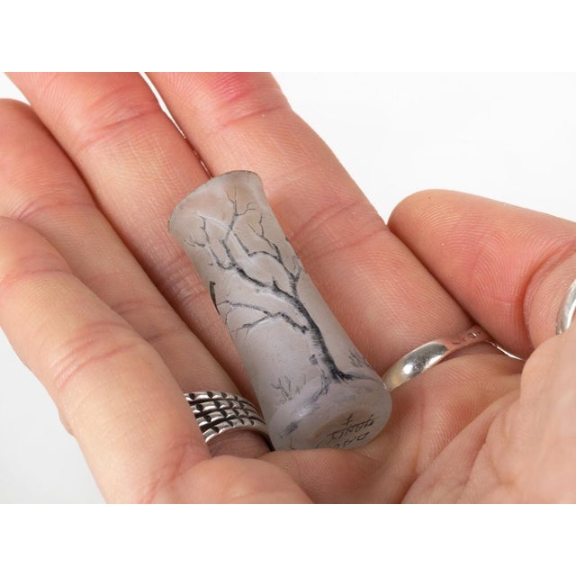 A signed Daum miniature vase from the early 1900s, featuring a delicate winter landscape in acid-etched and polychrome...