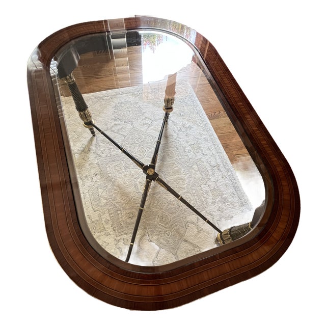 Neoclassical style rectangular table crafted from mahogany with rounded corners, inlays and inset beveled glass top, ebony...