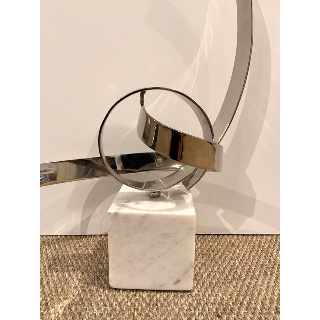 Modern John Richard Petite Ribbon Sculpture. Polished silver frame on square marble bottom. Original Retail $875. Showroom...