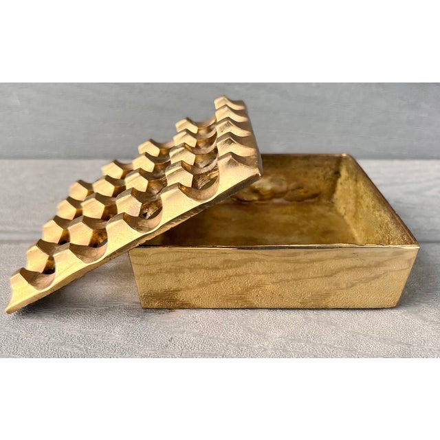 A striking vintage cast brass lidded box/ashtray featuring the iconic sculptural "Ultima" geometric design, offered in the...