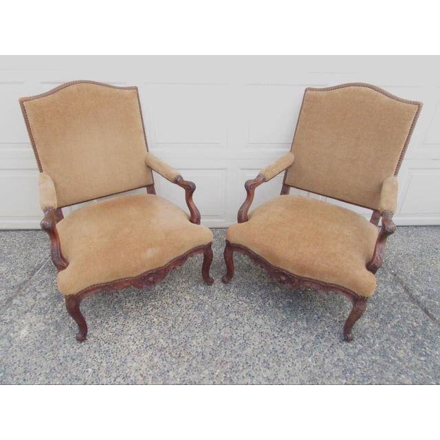 Pair of antique French Louis XV style walnut armchairs, c.1880 Known as fauteuils, these chairs have elegant scrolling...