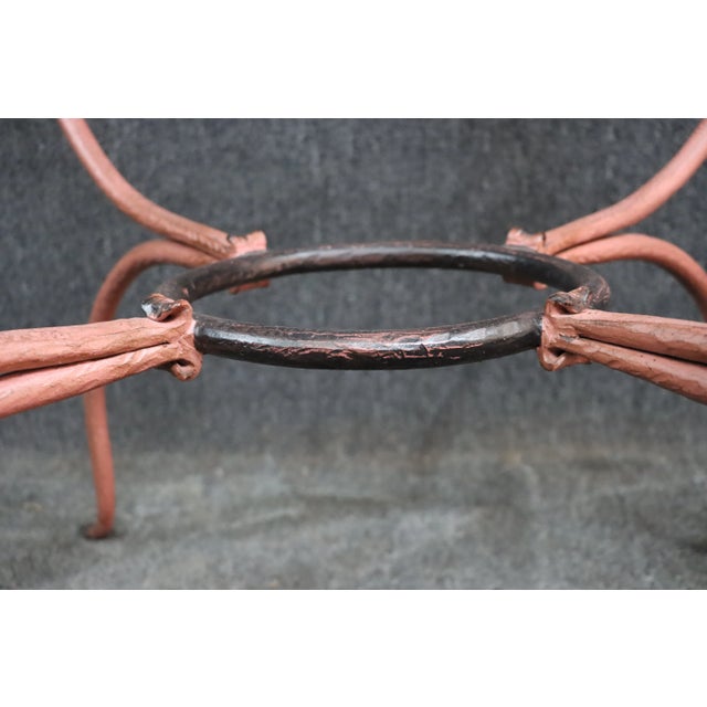 Ornate iron table base in salmon color, glass top not included. Matching chairs listed separately.