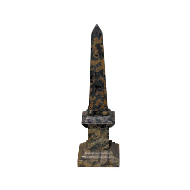 This is hand-carved marble Grand Tour style obelisk which features striking, deeply veined charcoal gray and cream...