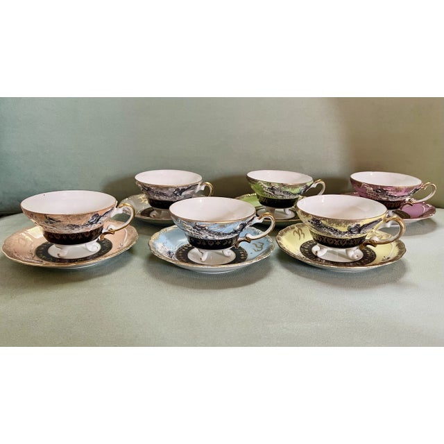 A fancifully elegant set of cups and saucers in a dragon motif. Teacups measure 2 1/4 inches tall, 4 1/2 inches wide from...