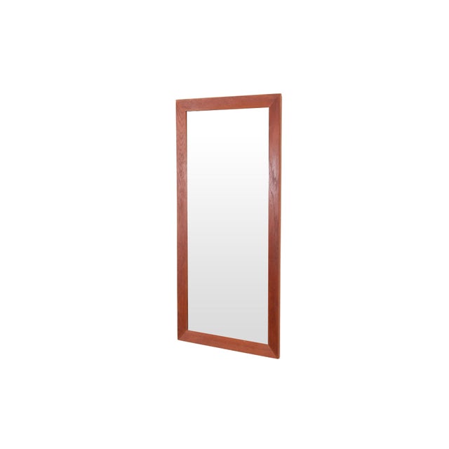 Rectangular Danish design mirror made of solid teak wood. This mirror has a beautiful wide teak edge and a straight,...