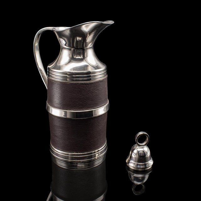This is a vintage polo club vacuum flask. An English, leather and silver plated cooling or heating jug, dating to the late...