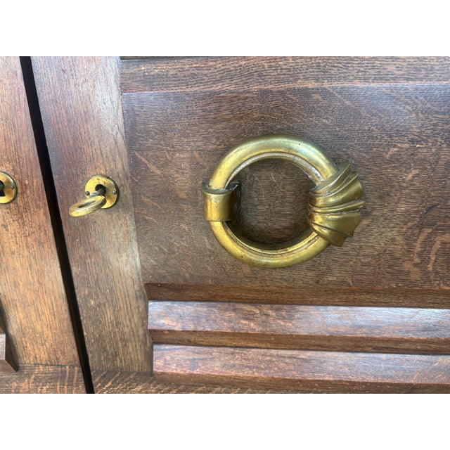 Oak sideboard attributed to Charles Dudouyt, French work, circa 1940. Gilt brass handles. Light wood interior with...
