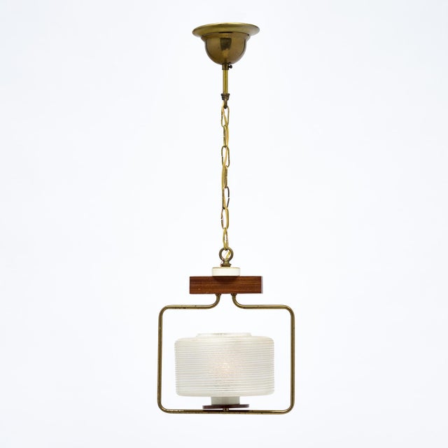 Petite chandelier from period mid-century Denmark. This fixture has a frosted blown glass shade over the single bulb. It...