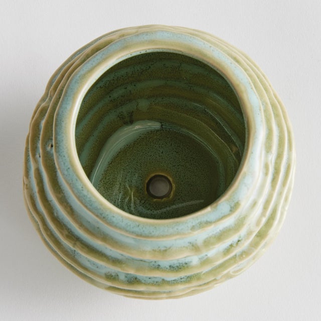 With a reactive glaze and hand finished ribbing detail, this charming sage green pot is a great find. Plant your favorite...