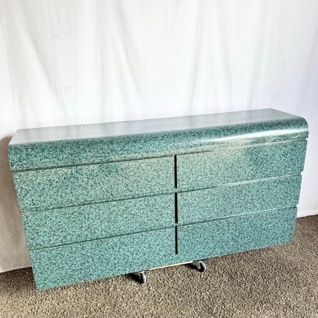 A striking example of late-20th-century design, this sculptural dresser features a bold faux-granite teal finish and a...