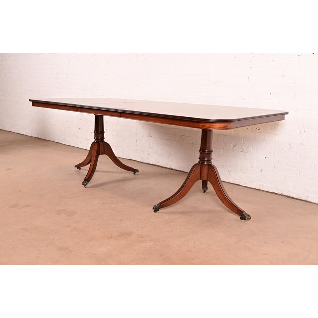 An exceptional Georgian or Regency style double pedestal extension dining table Attributed to John Widdicomb USA, Circa...