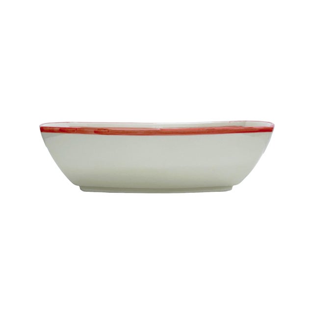 This handcrafted ceramic vessel features a vibrant red floral motif inspired by Mediterranean artistry. The intricate...