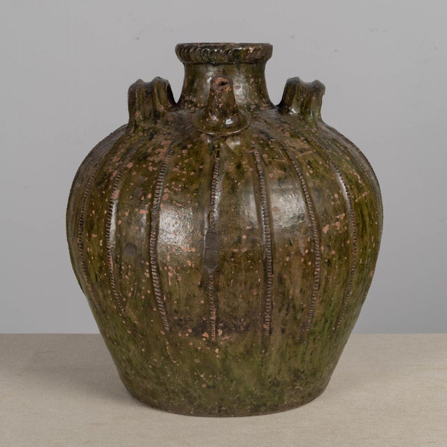 An 18th Century French Glazed terracotta walnut oil jug from the Perigord region in Southwestern France. Rich, rustic,...