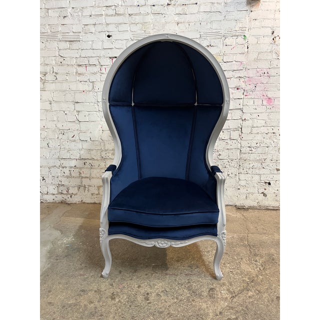 This French Porter Chair, also known as a French Hooded or Balloon Chair, has been re-upholstered in a luxurious navy blue...