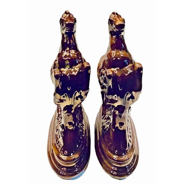 For your consideration we offer an antique matched pair of Staffordshire rearing stallion mantle piece figurines with a...