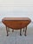 This oval mahogany Queen Anne style drop-leaf side table has plenty of charm. The gate-legs swing out on an angle to...