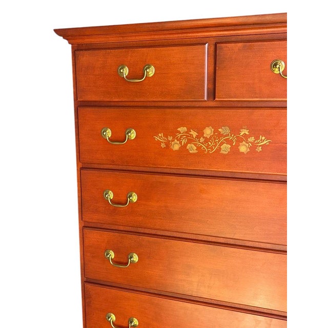 The Hitchcock Stenciled Solid Wood Tall Chest Dresser with Brass Pulls is a stylish and durable piece of furniture for any...