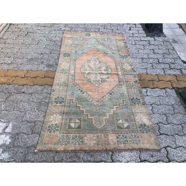 This is a vintage Turkish Oushak rug from the 1960s. The piece was hand-knotted.