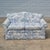 This is a lovely early 20th century camel back loveseat with newer blue and white toile de jouy upholstery. The loveseat...