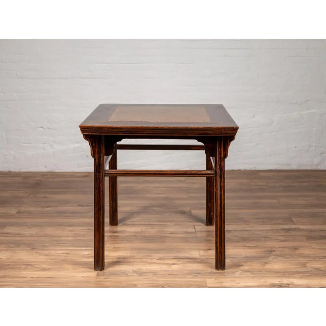 A Chinese 19th century elmwood center hall table with Ming dynasty 15th or 16th century courtyard stone inset. Born in...