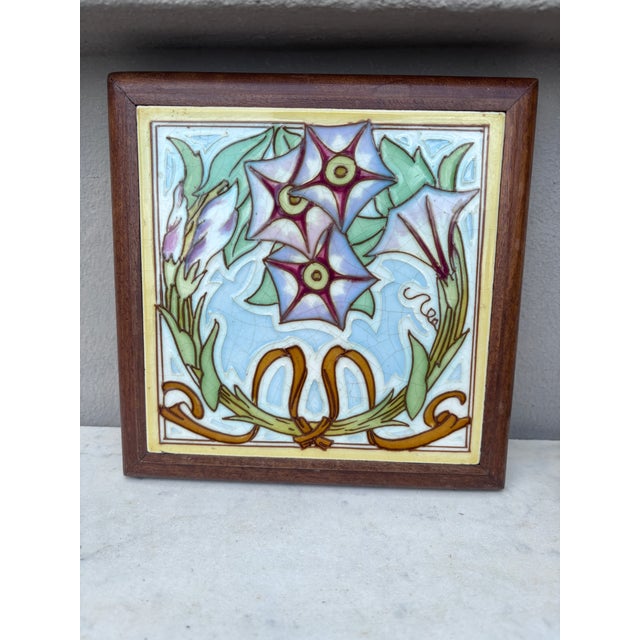 Art Nouveau Majolica trivet in a footed wood frame, circa 1900. Morning Glory 7.5" by 7.5"