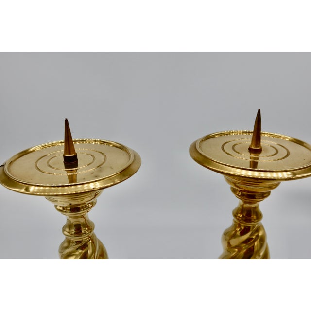 Set of two matching brass pillar candleholders. These decorative pieces are perfect for adding flair to a dining room,...
