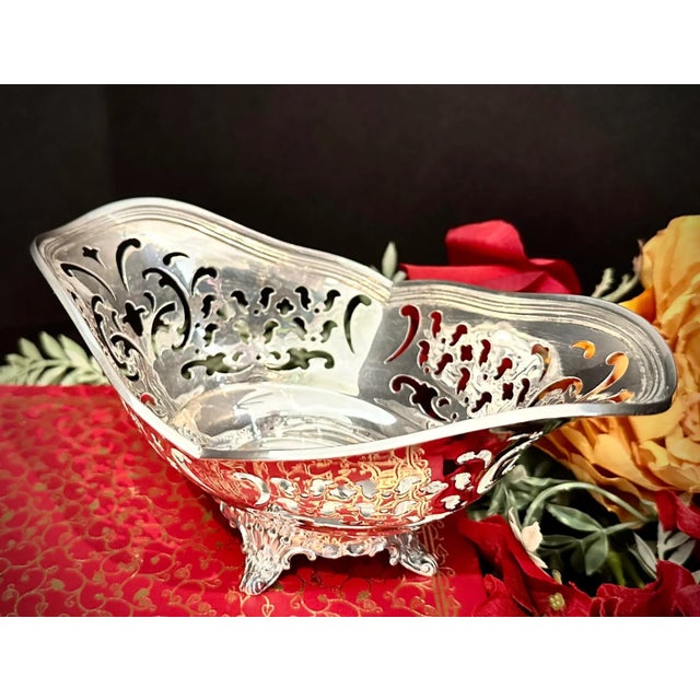 This is for a lovely uniquely shaped Sterling Silver bowl by Tiffany and Co. It has pierced decorated sides and sits on a...