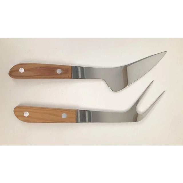 An unusual Austrian carving knife and fork, produced by Emboss Austria. Composed of stainless steel with wooden handles....