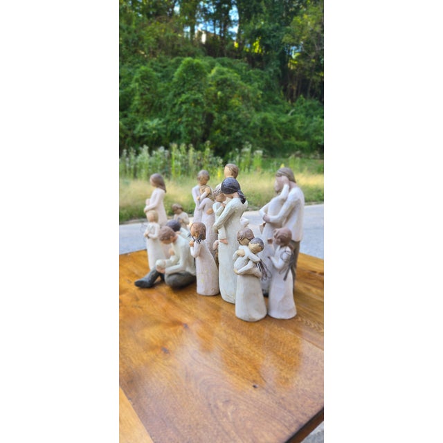 The collection includes figures embracing children, adults holding infants, and intimate family groupings. Their serene...
