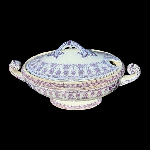 This antique English ceramic soup tureen is a charming example of traditional craftsmanship from the late 19th to early...