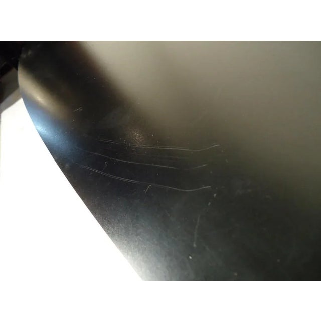 Sleek Mid-Century Modern black top coffee table with a unique and robust Eiffel metal base. Meticulously designed for...