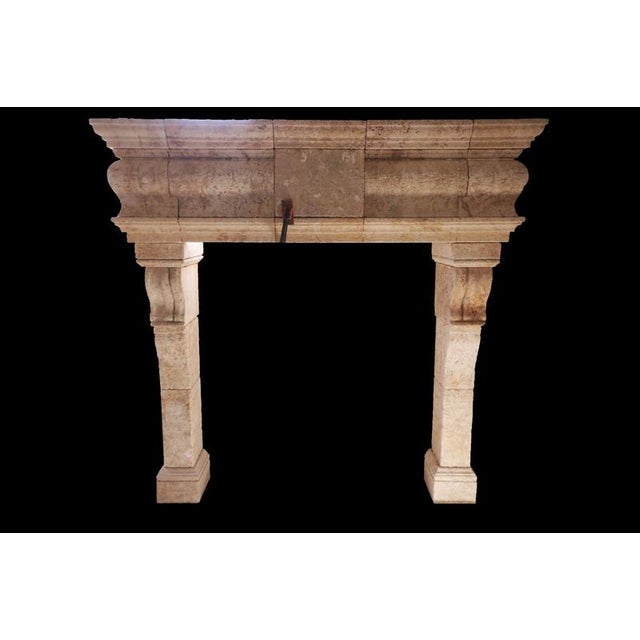 This substantial 20th-century French fireplace is hand-carved from limestone and showcases strong architectural lines with...
