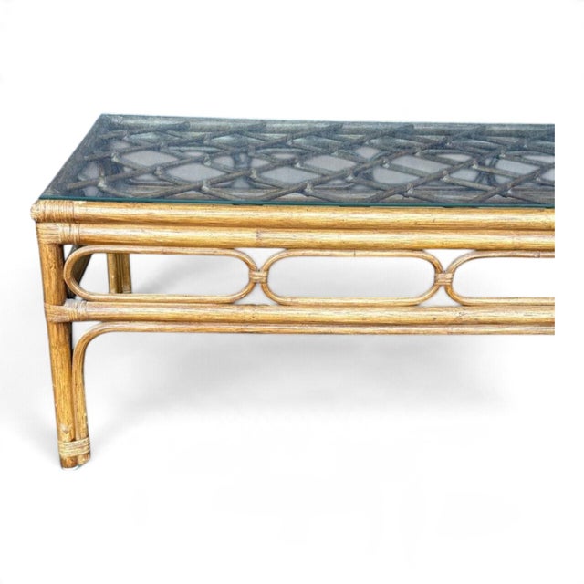 This vintage rattan coffee table with a glass top is a charming and unique piece of furniture. Standing at 16 inches tall...
