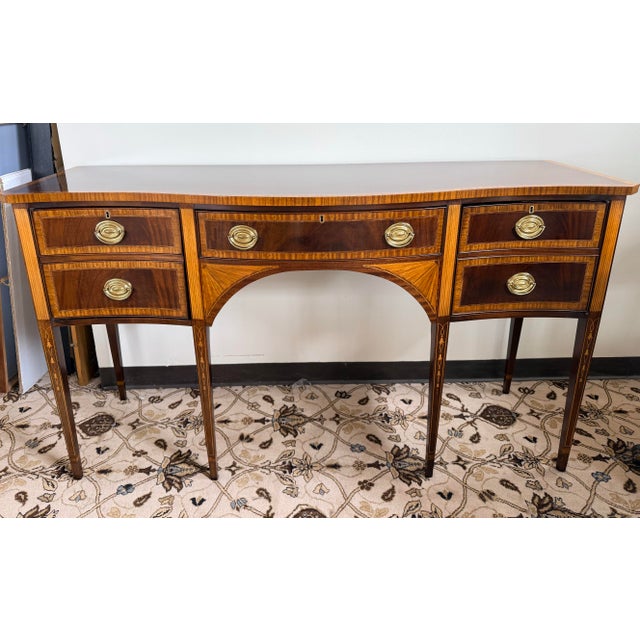 Elegant Councill Craftsmen mahogany sideboard or buffet featuring a serpentine front, satinwood-style banding, string...