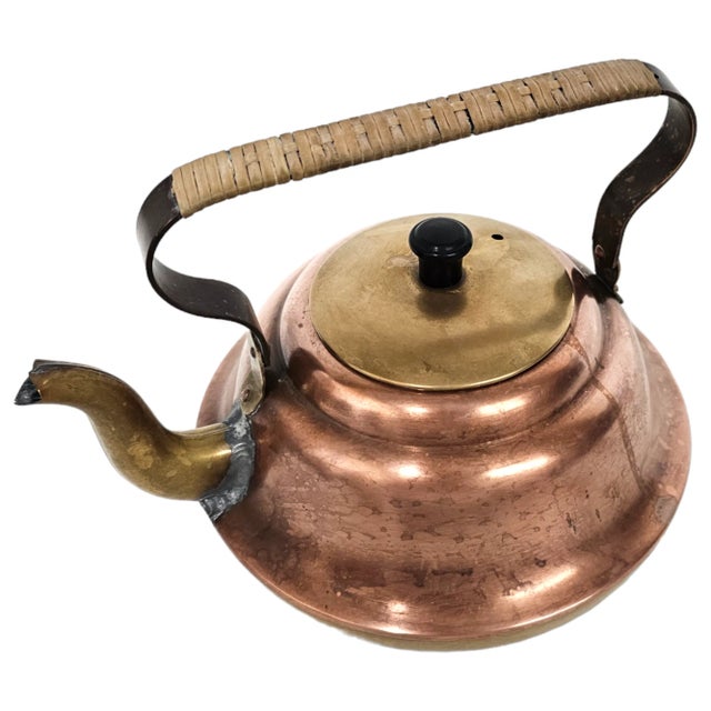 This vintage Dutch copper tea kettle is formed with a broad, stepped body and fitted with a brass lid and reinforced spout...