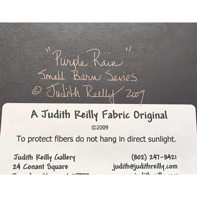The product is an original Judith Reilly quilted fabric piece titled "Purple Rain" from 2009. It is framed and signed by...
