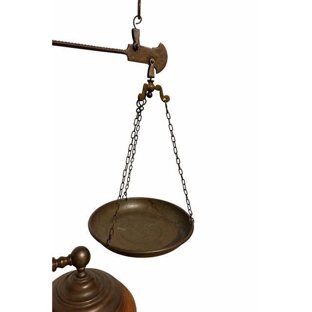 Beautiful antique brass balance scale featuring a classic hanging pan, sliding counterweight, and an integrated candle...