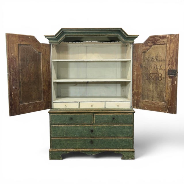 A beautiful, antique, two-piece cupboard in a deep green with a beautiful patina. The piece is practically original and in...